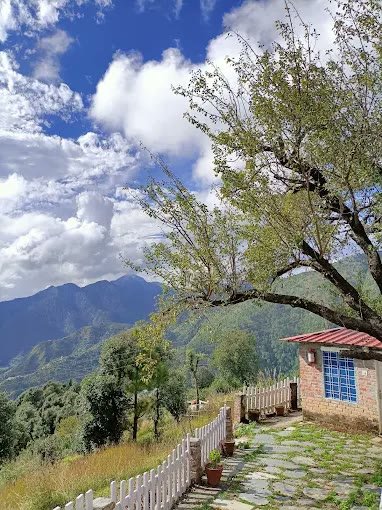 Mountain panoramic view framed by cottage and hillside